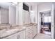 Bathroom featuring white cabinets, granite countertops, and a view into an adjacent bedroom at 102 W Vista View Pl, Mooresville, NC 28117