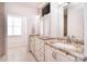 Bright bathroom with granite countertops, white cabinets, and a large mirror at 102 W Vista View Pl, Mooresville, NC 28117