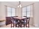 Bright dining area featuring windows with natural light and modern dark wood furniture at 102 W Vista View Pl, Mooresville, NC 28117