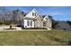 Charming home showcasing stone accents, complemented by black shutters and a well-manicured lawn at 102 W Vista View Pl, Mooresville, NC 28117