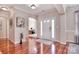 Elegant foyer with gleaming hardwood floors and a glimpse of the office space at 102 W Vista View Pl, Mooresville, NC 28117