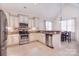 Well-lit kitchen featuring stainless steel appliances, tiled backsplash, breakfast bar, and cozy dining area at 102 W Vista View Pl, Mooresville, NC 28117