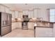 Bright kitchen with stainless appliances, granite countertops, and ample cabinet space at 102 W Vista View Pl, Mooresville, NC 28117