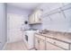 Well-organized laundry room with modern appliances, sink, and overhead storage at 102 W Vista View Pl, Mooresville, NC 28117