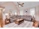 Cozy living room showcasing a fireplace, plush sofa, hardwood flooring, and recessed lighting at 102 W Vista View Pl, Mooresville, NC 28117