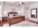 Spacious main bedroom featuring a wooden bed frame, ceiling fan, and a decorative wall art piece at 102 W Vista View Pl, Mooresville, NC 28117