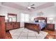 Main bedroom features a wooden bed frame, ceiling fan, and decorative wall art at 102 W Vista View Pl, Mooresville, NC 28117