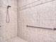 Tiled walk-in shower featuring a shower head, a built-in bench, and a grab bar at 102 W Vista View Pl, Mooresville, NC 28117