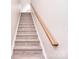 Carpeted stairs with a wooden handrail leading to the upper level of the home at 102 W Vista View Pl, Mooresville, NC 28117