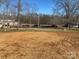 Empty lot with some trees and a church in the background at 1027 Adams St, Statesville, NC 28677