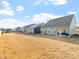 Backyard view featuring the home's exterior, patio, and a spacious grassy area at 1036 Barnette Farm Ln, Monroe, NC 28110