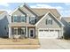 Charming two-story home with gray siding, black shutters, and a two-car garage at 1036 Barnette Farm Ln, Monroe, NC 28110