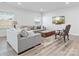 Comfortable living room with hardwood floors, neutral-toned sofas, and a mounted TV at 1036 Barnette Farm Ln, Monroe, NC 28110