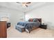 Spacious main bedroom featuring tray ceilings, a ceiling fan, and two windows for natural light at 1036 Barnette Farm Ln, Monroe, NC 28110