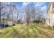 Spacious backyard with a garden, mature trees, a storage shed, and lush, well-maintained lawn at 11918 Parks Farm Ln, Charlotte, NC 28277