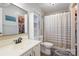 Bathroom featuring a shower-tub combo, white vanity, and a large, framed mirror at 11918 Parks Farm Ln, Charlotte, NC 28277