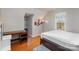 Bedroom with wood floors, bright lighting, and a cozy bed, and a large workspace at 11918 Parks Farm Ln, Charlotte, NC 28277