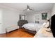 Bedroom with a ceiling fan, shutters, and hardwood floors, plus modern gray finishings at 11918 Parks Farm Ln, Charlotte, NC 28277