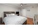 Bedroom with hardwood floors, ceiling fan, desk, and a large window at 11918 Parks Farm Ln, Charlotte, NC 28277