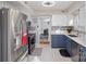 Updated kitchen featuring stainless steel appliances, blue and white cabinets, and tile backsplash at 11918 Parks Farm Ln, Charlotte, NC 28277