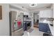 Updated kitchen featuring stainless steel appliances, blue and white cabinets, and tile backsplash at 11918 Parks Farm Ln, Charlotte, NC 28277