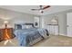 Neutral bedroom featuring a bed, hardwood floors, and dual storage dressers at 12325 Parks Farm Ln, Charlotte, NC 28277