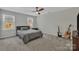 Neutral bedroom featuring a bed, carpet, and dual guitars at 12325 Parks Farm Ln, Charlotte, NC 28277