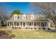 Inviting home featuring a cozy front porch, dormer windows, and a well-maintained lawn at 12325 Parks Farm Ln, Charlotte, NC 28277