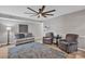 Bright living room with neutral paint, hardwood floors, and ceiling fan at 12325 Parks Farm Ln, Charlotte, NC 28277