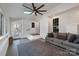 Bright sunroom with a large rug, white painted trim, and a gray sofa at 12325 Parks Farm Ln, Charlotte, NC 28277