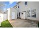 Exterior view of a home with a white fence, artificial grass and a concrete patio at 12584 Jessica Pl, Charlotte, NC 28269