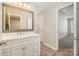 Charming bathroom features wood-look flooring, a marble countertop vanity, and a framed mirror at 12584 Jessica Pl, Charlotte, NC 28269