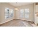 Dining area with natural light, wood-style floors, and view of the stylish light fixture at 12584 Jessica Pl, Charlotte, NC 28269