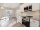 Well-designed kitchen with stainless steel appliances, granite countertops, and white cabinets at 12584 Jessica Pl, Charlotte, NC 28269