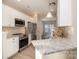 Modern kitchen featuring stainless steel appliances, granite countertops, and white cabinets at 12584 Jessica Pl, Charlotte, NC 28269