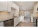 Bright kitchen featuring stainless steel appliances, granite countertops, and white cabinets at 12584 Jessica Pl, Charlotte, NC 28269