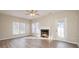 Living room features a fireplace, ceiling fan, wood floors, natural light, and a back door at 12584 Jessica Pl, Charlotte, NC 28269