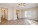 Open-concept living room with wood floors and natural light open to the kitchen at 12584 Jessica Pl, Charlotte, NC 28269