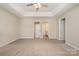 Large main bedroom featuring a ceiling fan, neutral paint, carpet, and bathroom access at 12584 Jessica Pl, Charlotte, NC 28269