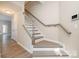 Inviting foyer showcasing staircase with gray trim and wood-style floors, creating a warm welcome at 12584 Jessica Pl, Charlotte, NC 28269