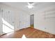 Bedroom with wood floors, double closets, and ceiling fan at 12822 Angel Oak Dr, Huntersville, NC 28078