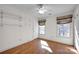 Bedroom with wood floors, built-in shelves, and window at 12822 Angel Oak Dr, Huntersville, NC 28078