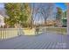 Back deck with view of backyard and surrounding trees at 12822 Angel Oak Dr, Huntersville, NC 28078