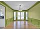 Dining room with green walls and hardwood floors, and a view to the kitchen at 12822 Angel Oak Dr, Huntersville, NC 28078