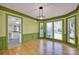 Dining room with green walls and hardwood floors, and a view to the kitchen at 12822 Angel Oak Dr, Huntersville, NC 28078