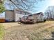 Rear exterior view of the home featuring a deck, well-maintained landscaping, and a spacious backyard at 12907 Mccahan Ln, Huntersville, NC 28078