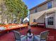 Outdoor deck with built-in seating and white chairs provides an area for relaxation at 12907 Mccahan Ln, Huntersville, NC 28078