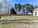 Spacious backyard with lush lawn and mature trees, providing a serene and private outdoor setting at 12907 Mccahan Ln, Huntersville, NC 28078