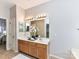 Well-lit bathroom with double sinks, a large mirror, and classic vanity cabinets at 12907 Mccahan Ln, Huntersville, NC 28078