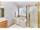 Bright bathroom featuring a soaking tub, a separate glass shower, and ample natural light at 12907 Mccahan Ln, Huntersville, NC 28078